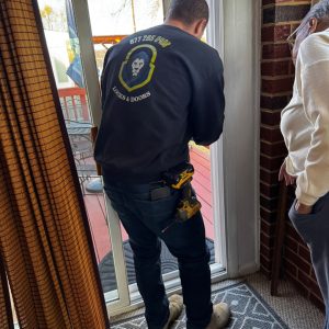 An Emergency Locksmith Assisting A Homeowner With A Sliding Glass Door Lock In Severn, Md.