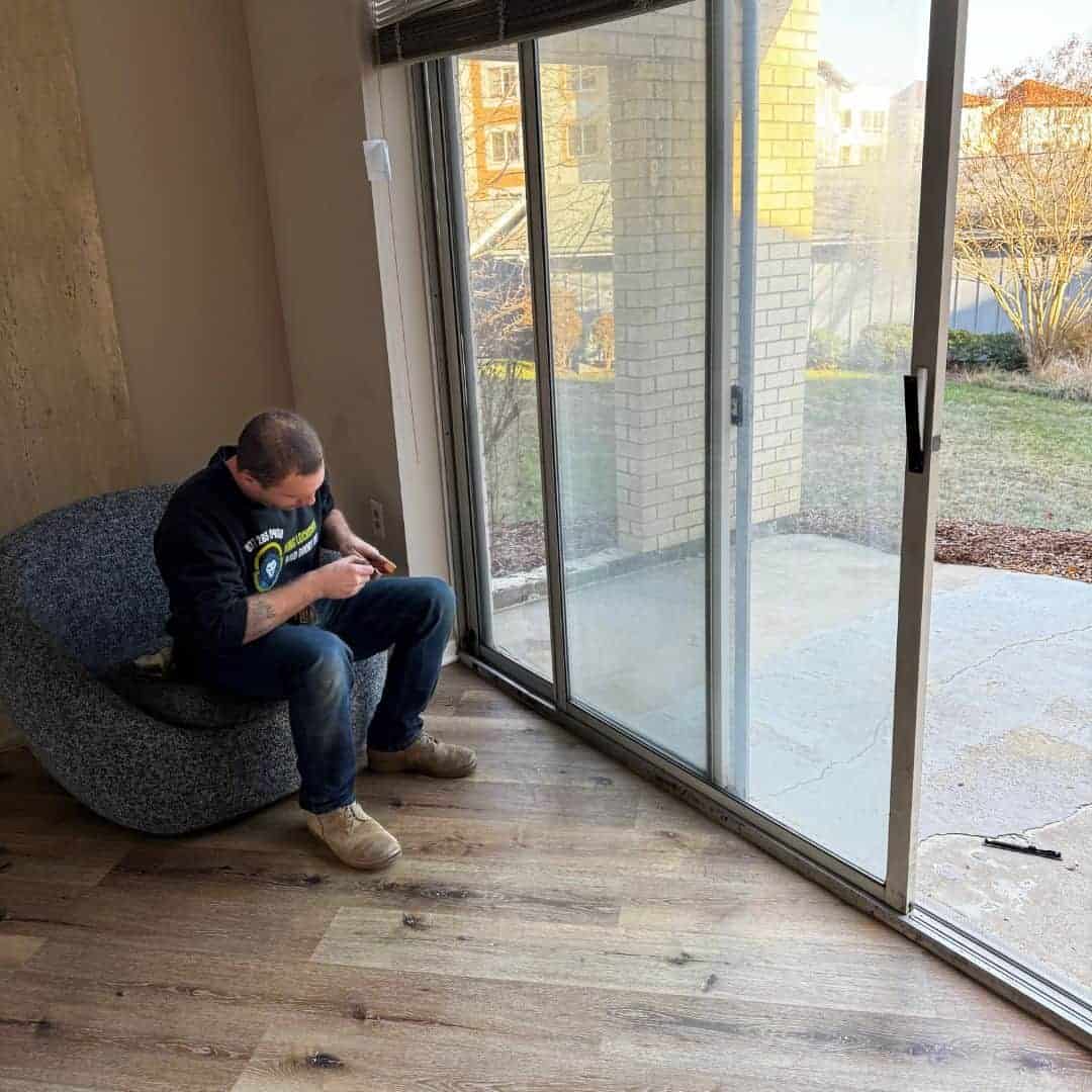 Residential 18Th Street Ne Locksmith Inspecting And Repairing A Sliding Glass Door Lock.