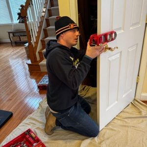 Our Residential Locksmith Bladensburg Installing A New Lock On A White Interior Door.