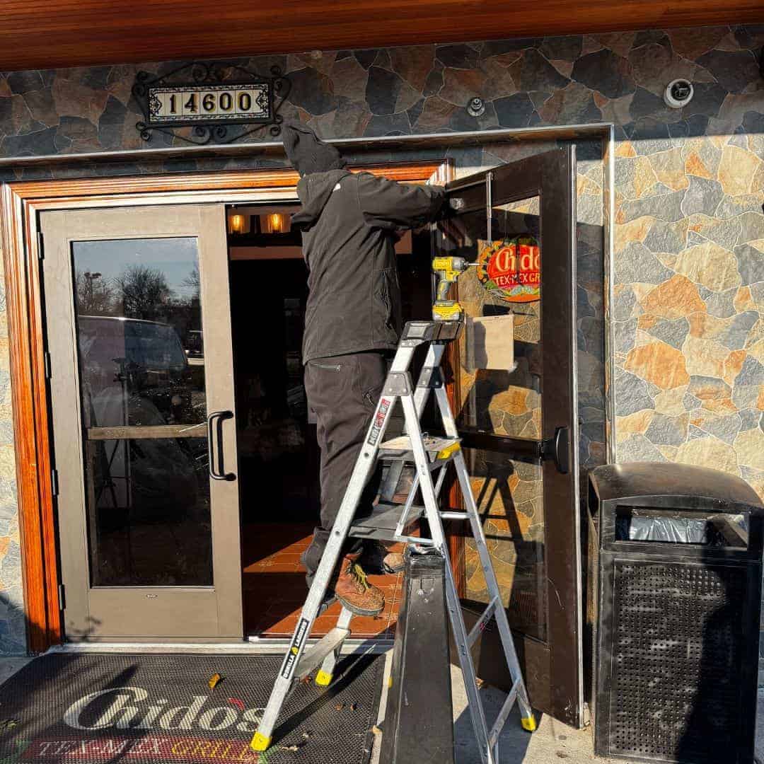 King Locksmith technician services a commercial entry door at a Hyattsville, Maryland business to ensure secure and reliable access for daily operations.