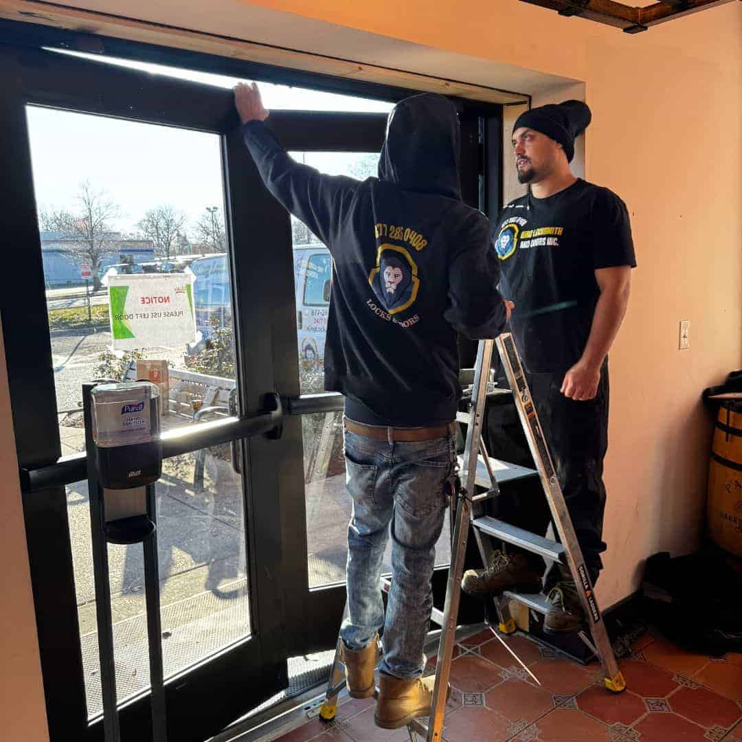 King Locksmith Technicians Adjusting Commercial Glass Entry Door Hardware During On-Site Service By A King Locksmith And Doors Expert In Rockville Md, Ensuring Secure Access And Reliable Door Operation For A Local Business
