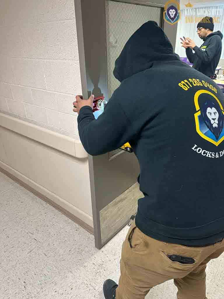 Commercial locksmith from King Locksmith, repairing and securing commercial door lock hardware inside an Elkridge Maryland office building for code-compliant access and facility protection