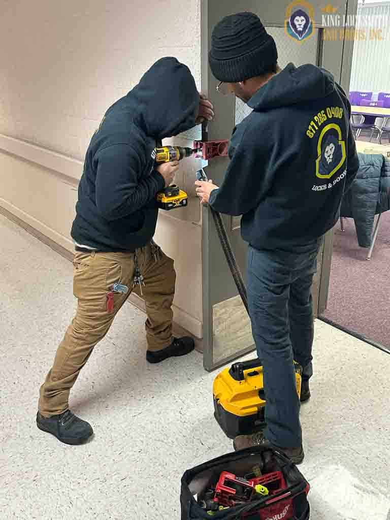 King Locksmith and Doors commercial locksmith technicians installing and securing commercial door hardware in Elkridge Maryland for professional, code-compliant facility protection