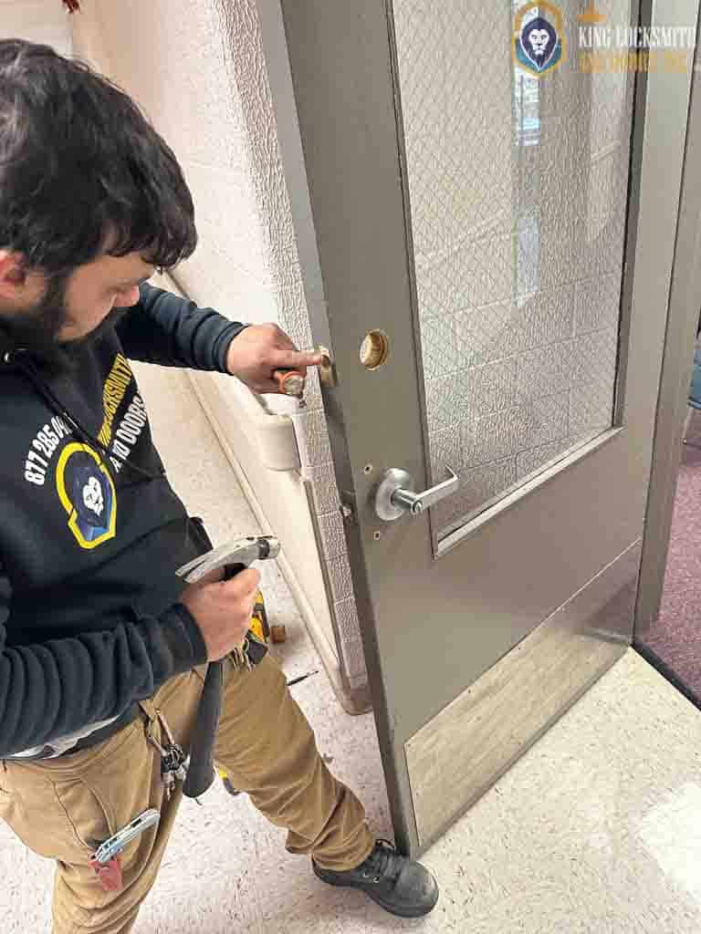 Commercial locksmith installing door hardware and adjusting commercial lock system for a business property in Bladensburg, MD