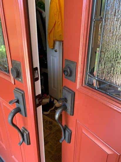 Residential locksmith service in Elkridge MD upgrading and securing front entry door with modern handleset and high-security lock hardware for enhanced home protection