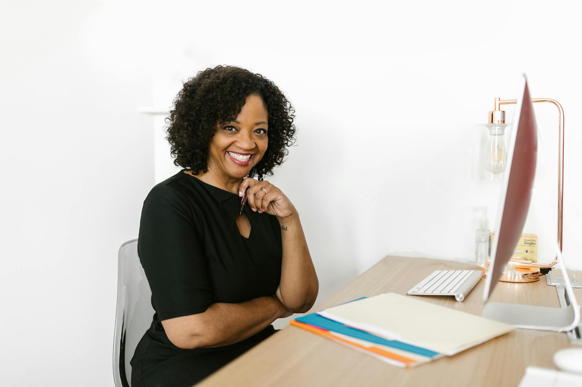 a woman sitting on her chair while seriously looking at the camera