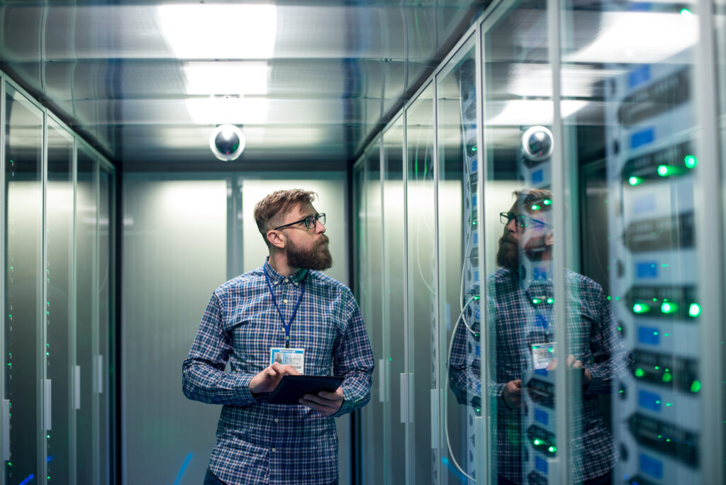 Technician reviewing server racks in a data center, representing large-scale AI infrastructure and compliance requirements under Illinois SB 315