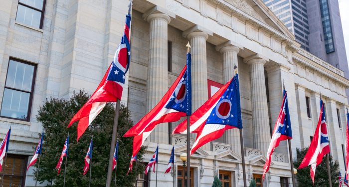 Ohio Statehouse building with Ohio flags, symbolizing Ohio Attorney General leadership change and business compliance environment