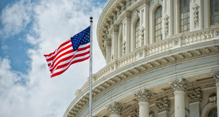 Washington DC Capitol dome detail with waving american flag