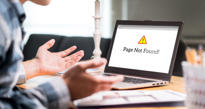 Page not found and error in laptop. Bad or slow internet connection. Frustrated man spreading hands in home office desk. Broken computer not working. Online information problem. Alert icon in website.