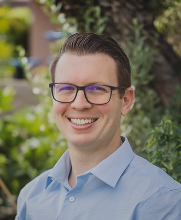 Headshot of a man in a blue shirt outside | Shaun Kennedy
