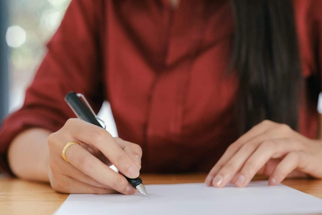 woman signing a document