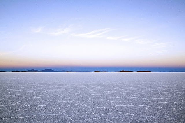 A landscape of cracked and dry salt flats, symbolizing the symptoms of dry air in winter. including dry and cracked skin.