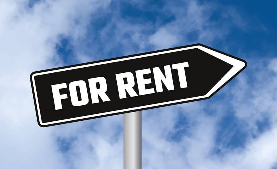 Black arrow sign reading “For Rent” against a blue sky, symbolizing the option to rent a water heater.
