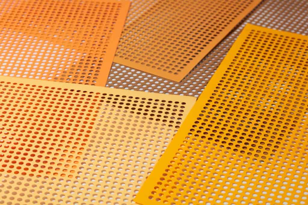Orange perforated non-slip bathmats scattered on the floor are great ideas for safety in the bathtub for seniors. 