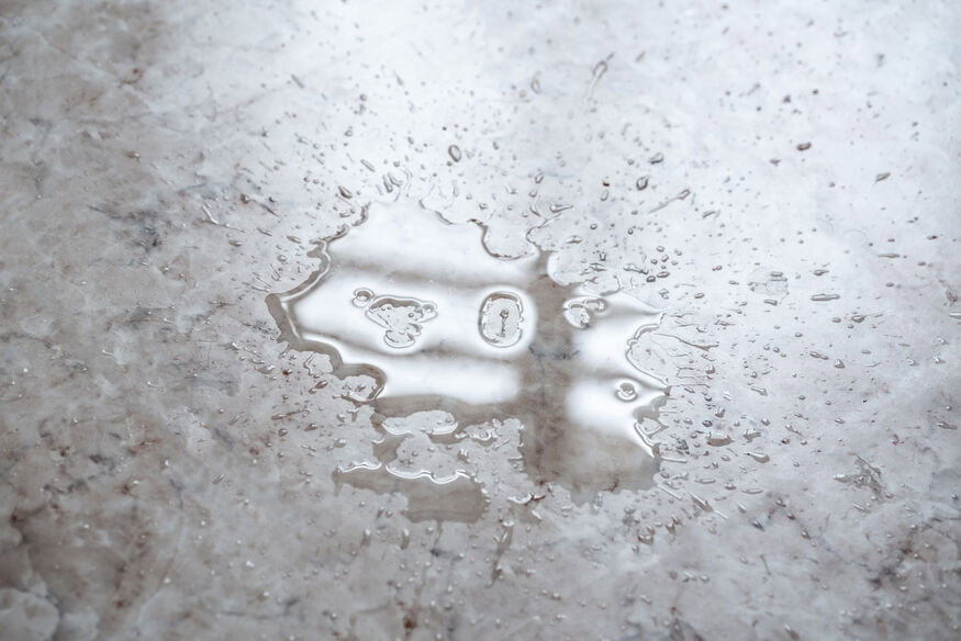 A small pool of water on a cement basement floor can be the first indication of water heater failure, and if not addressed, may lead to a water heater explosion.