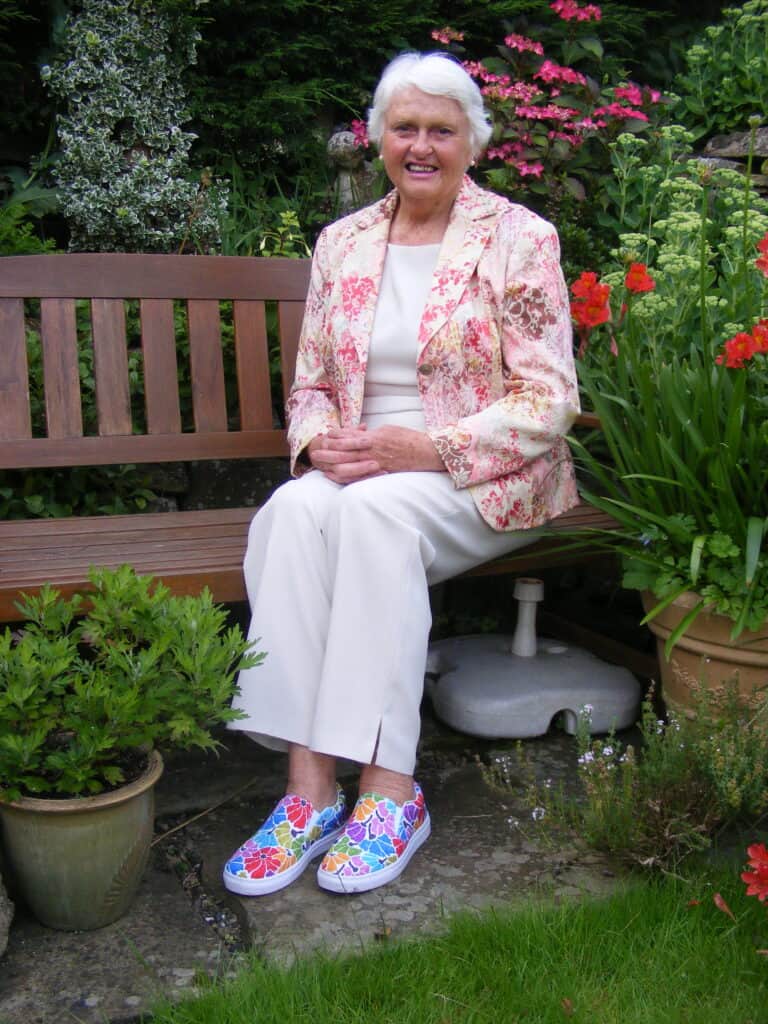 My friend Sue wearing her cool Ro Carr Studio slip on canvas shoes printed with Pride Rainbow Bouquet floral pattern.