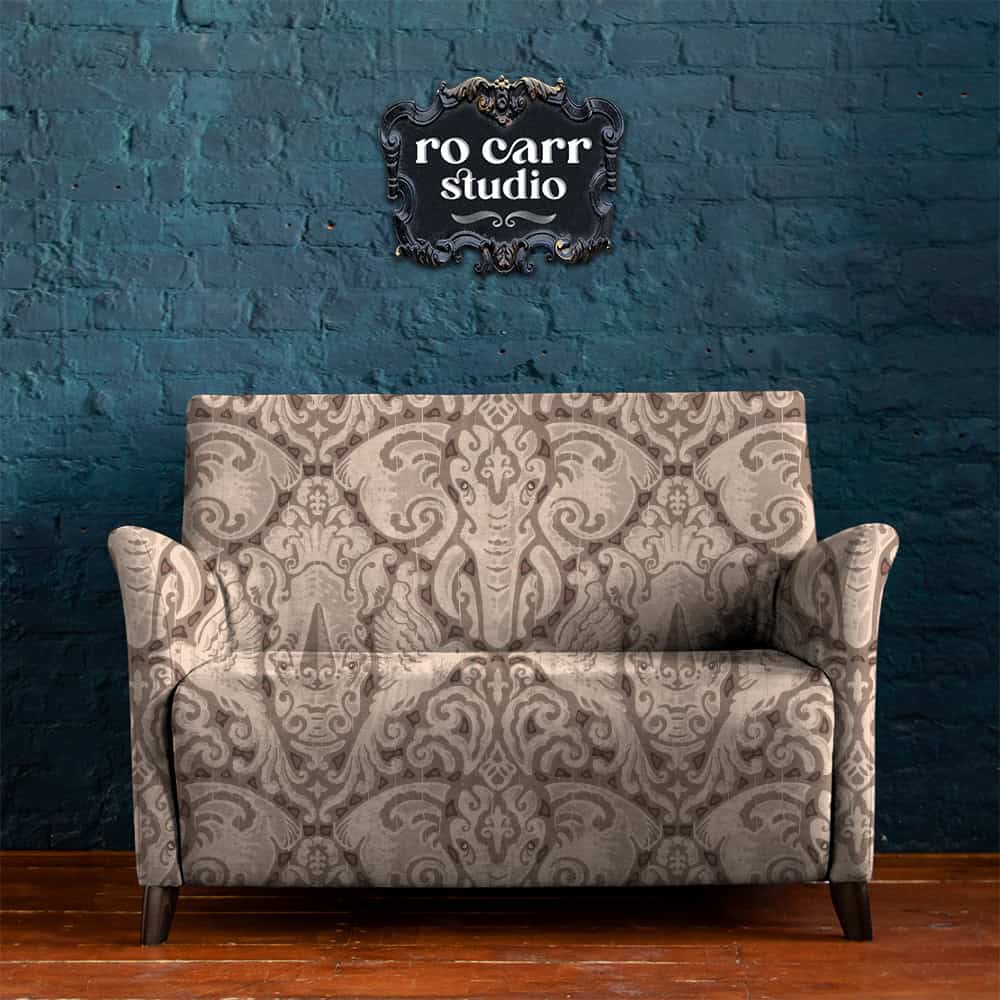 Kalahari Safari pattern shown as upholstery on love seat, against a brick wall.