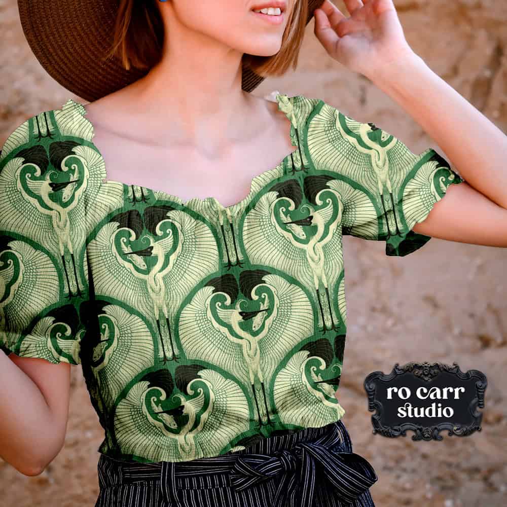 Mockup of a woman wearing a blouse printed with egret pattern on jade green.