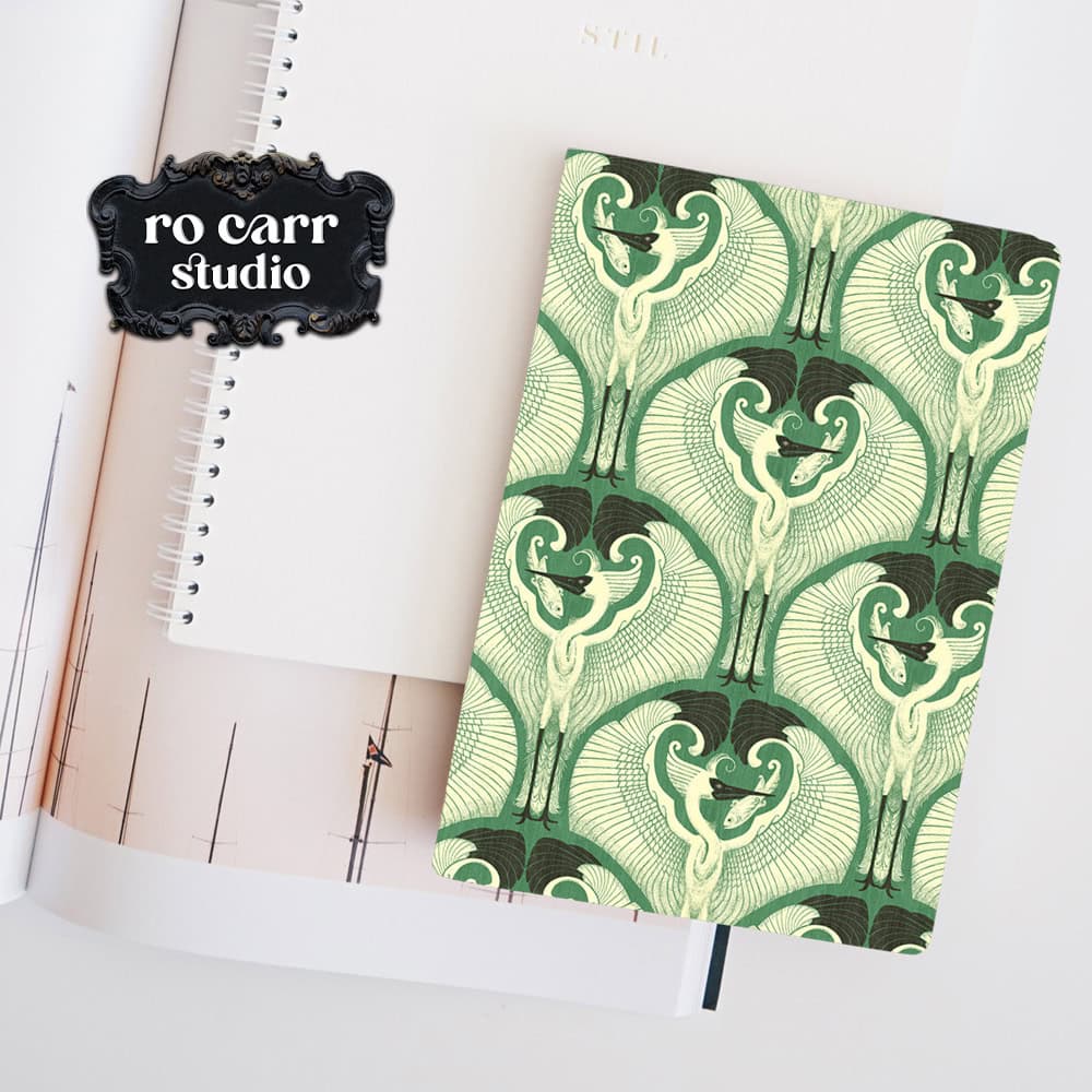 Mockup of a journal with the egret pattern printed on the cover.