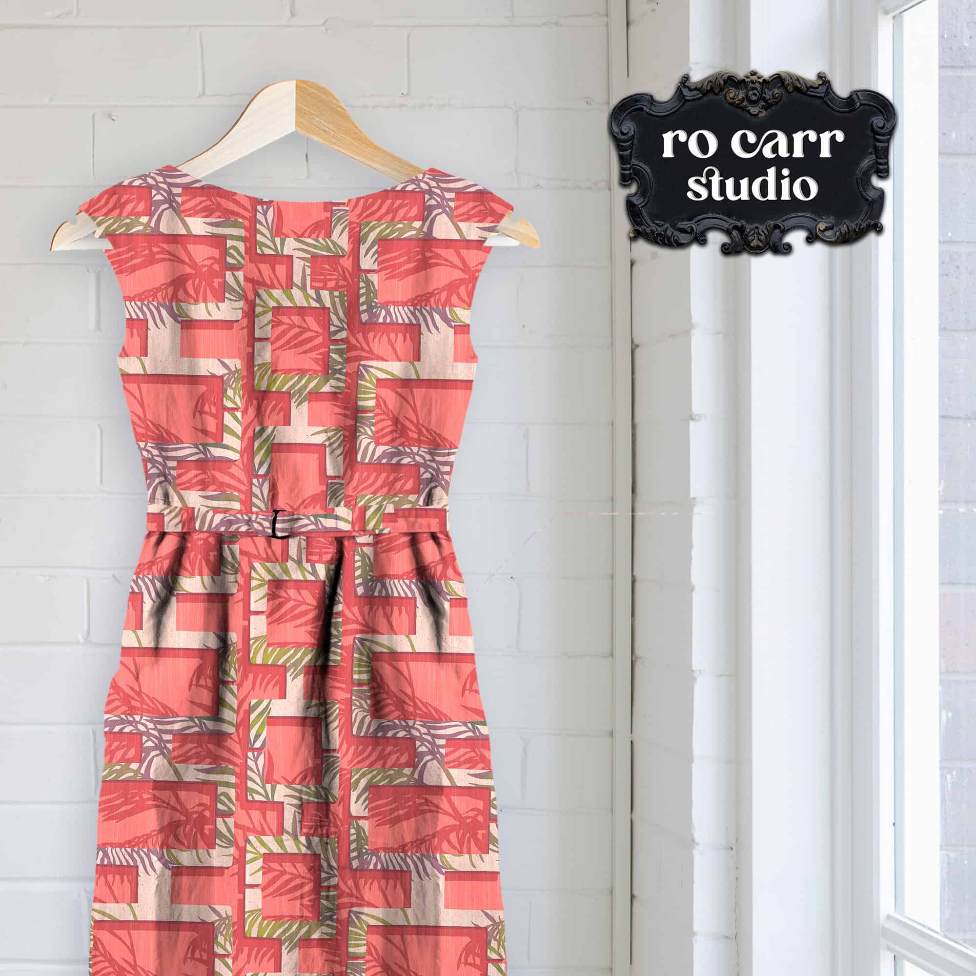 Mockup of a shift dress on a hanger, made from breeze block design in pink.