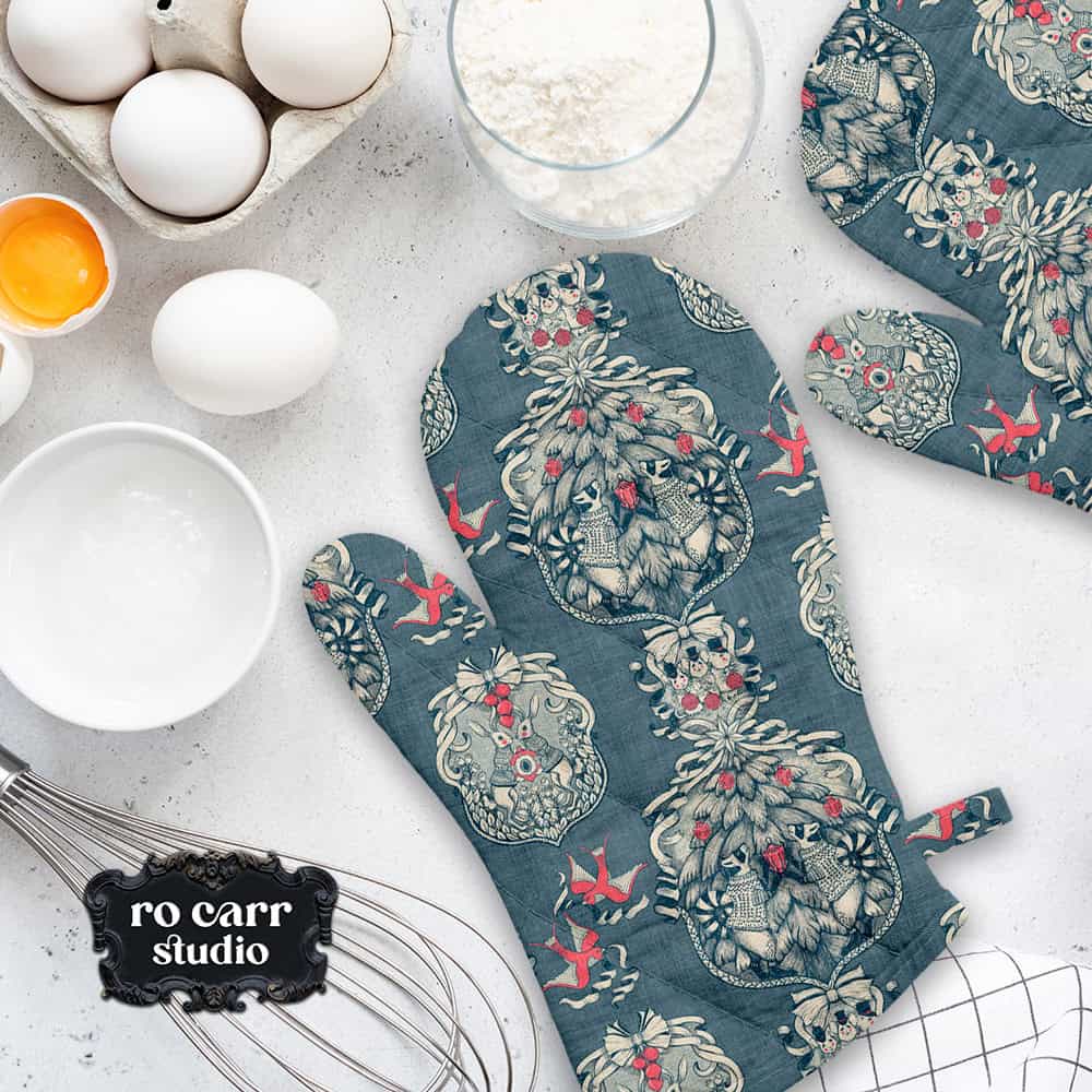 Toile pattern shown in a kitchen scene, mocked as a pair of oven mitts.