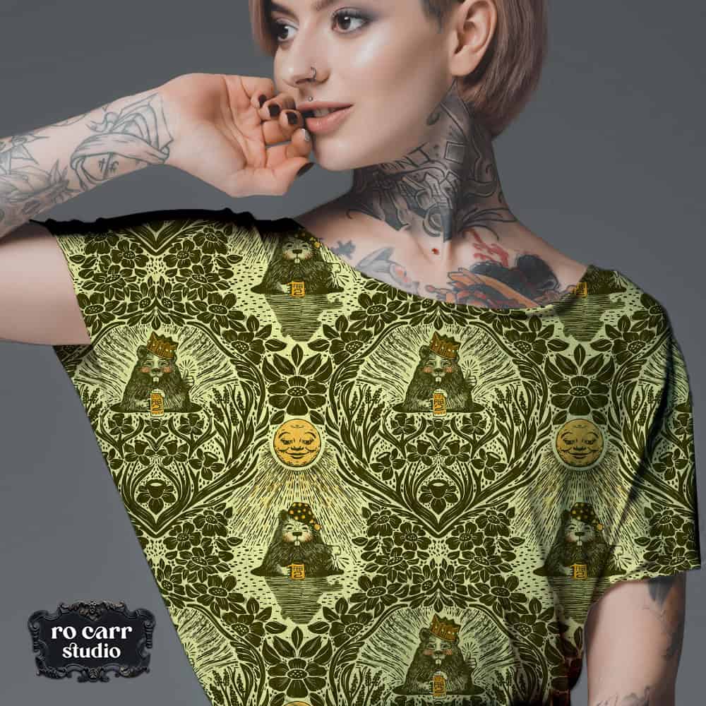 Young tattooed woman wearing tee shirt printed with the olive colorway.
