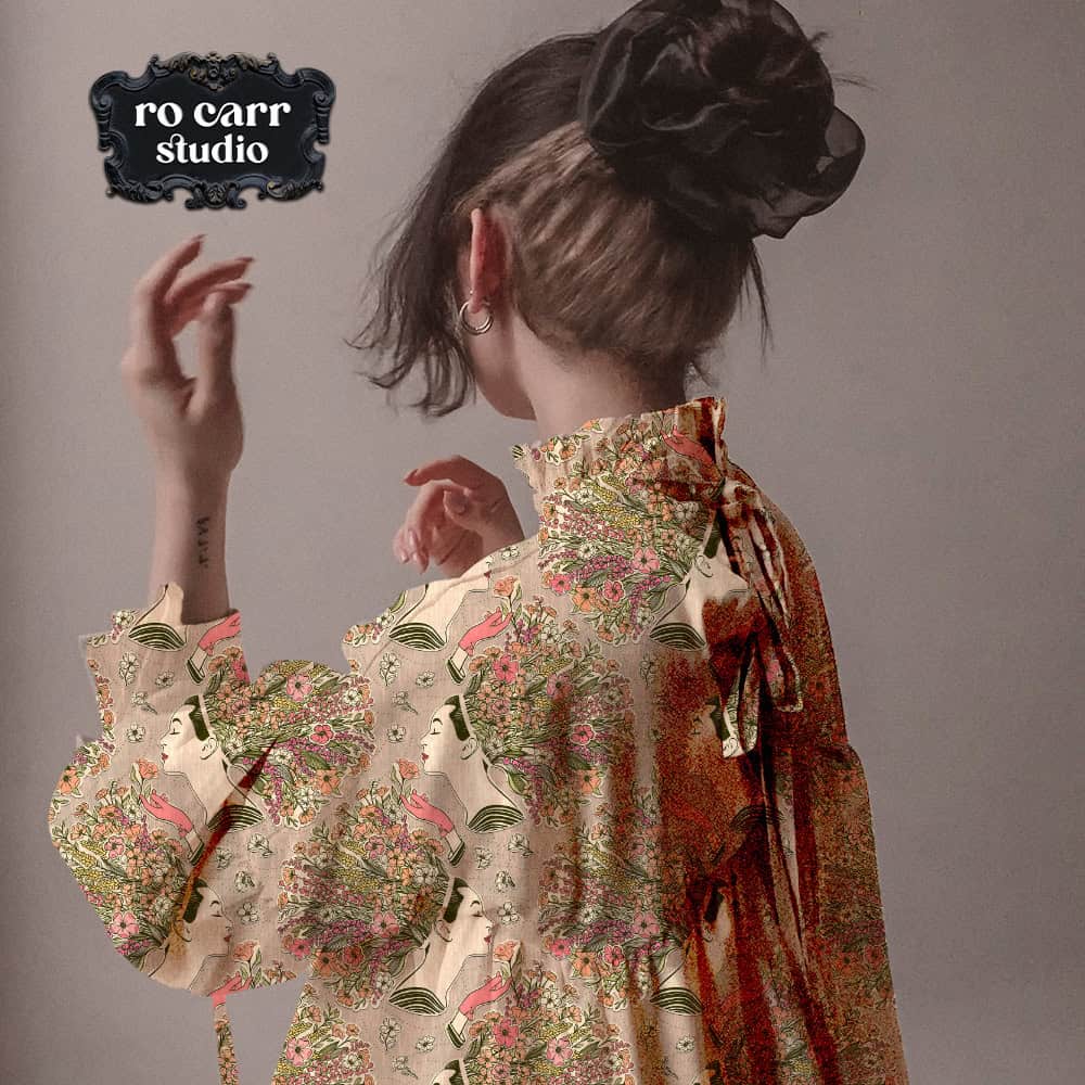 Model wearing a loose blouse featuring a wildflower collage pattern.
