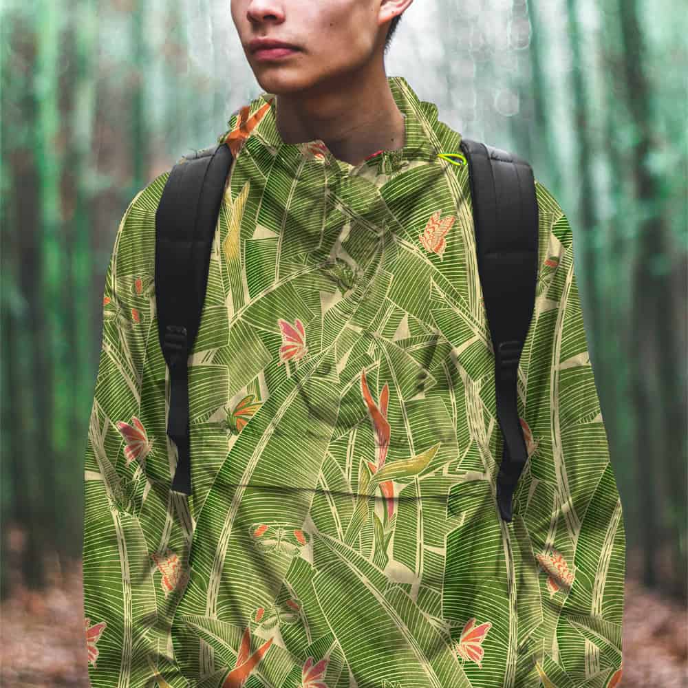 Young man wearing a Goodnight Jungle hooded jacket in a bamboo forest.