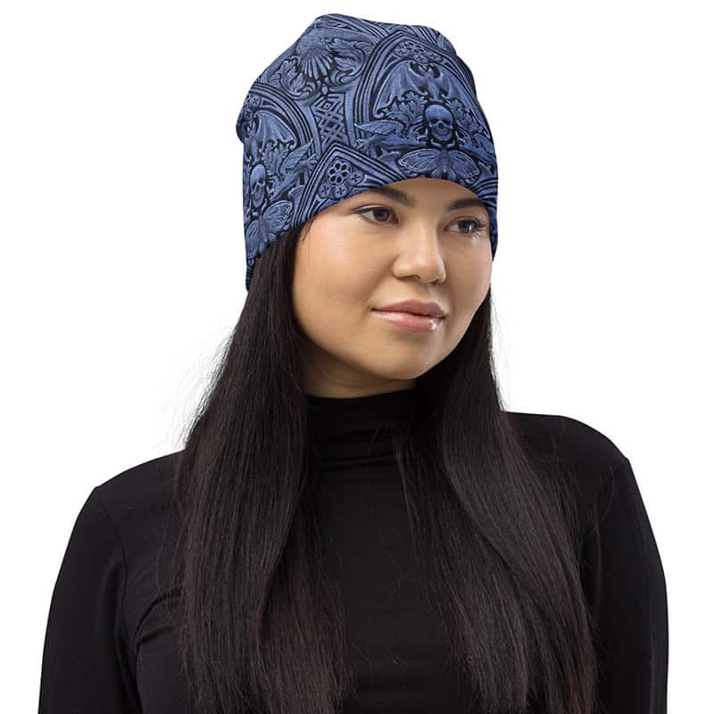 Woman wearing The Grande Macabre Beanie in Twilight Blue, front view showing gothic pattern.