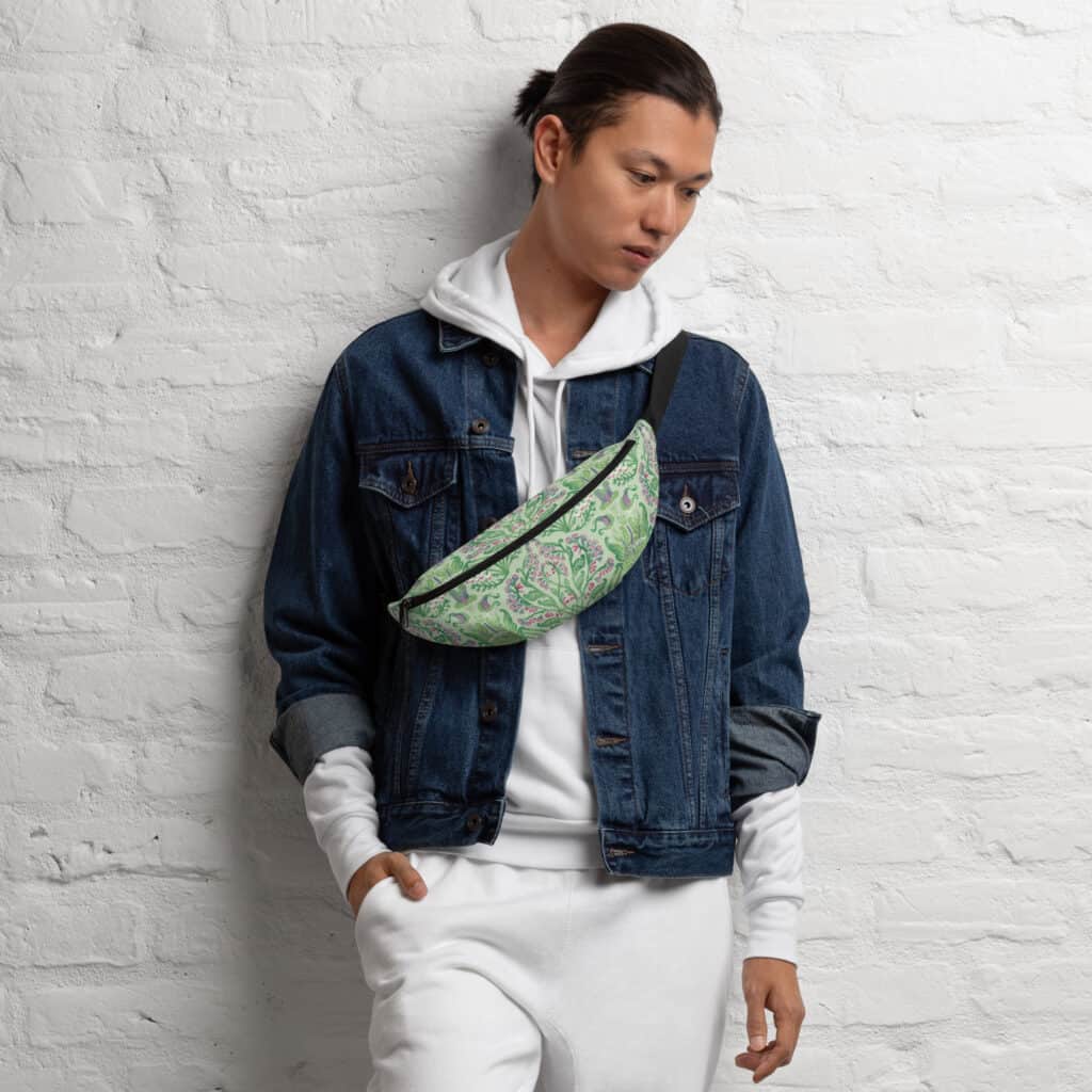 Man wearing a green Art Nouveau botanical fanny pack cross-body over a denim jacket.
