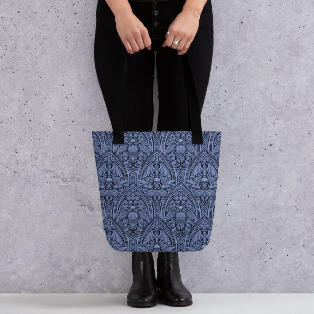 Woman holding The Grande Macabre in Twilight gothic pattern tote bag.
