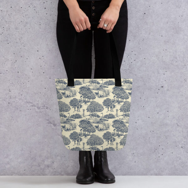 Tote bag printed with birds & birders toile de juoy - shown held by woman.