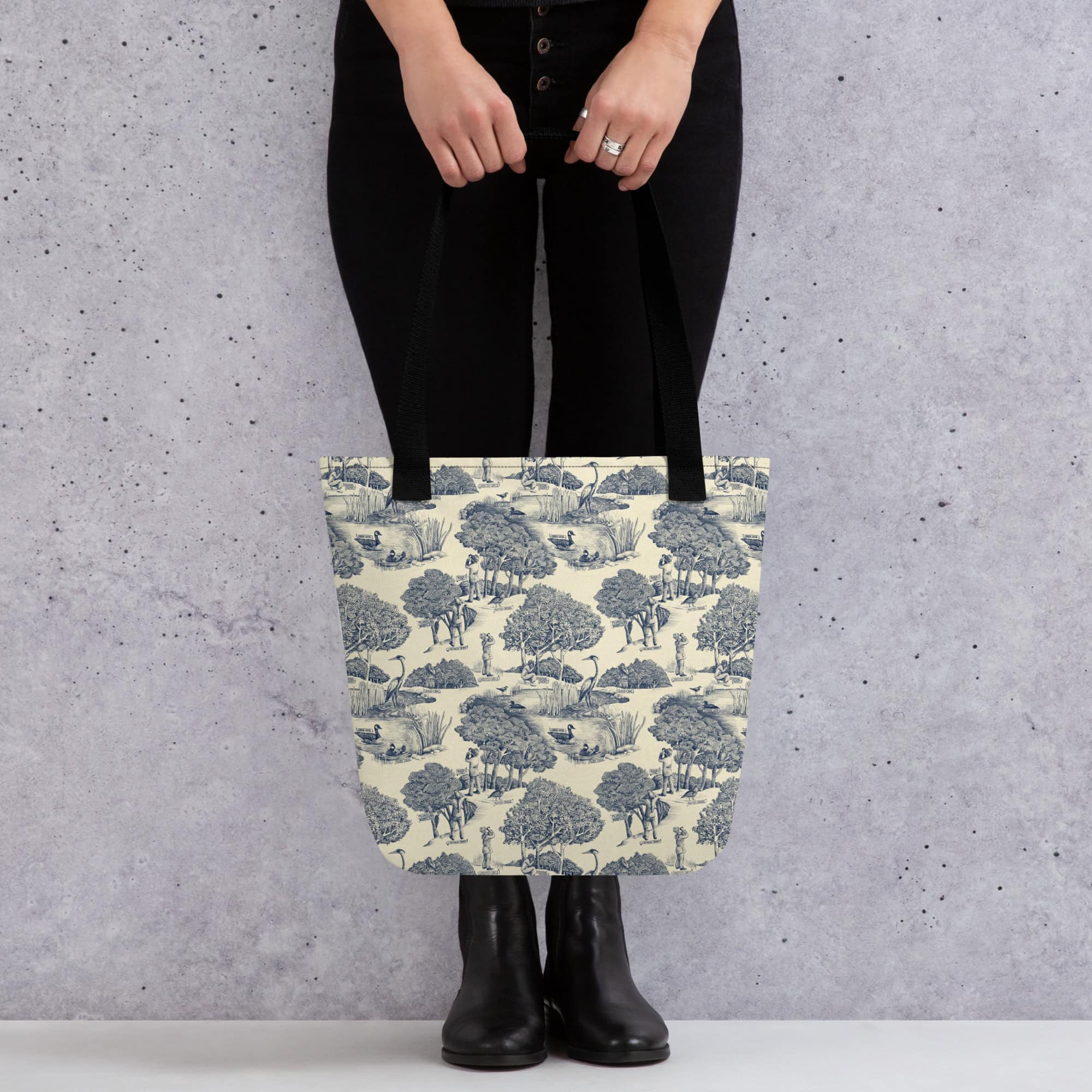 Tote bag printed with birds & birders toile de juoy - shown held by woman.