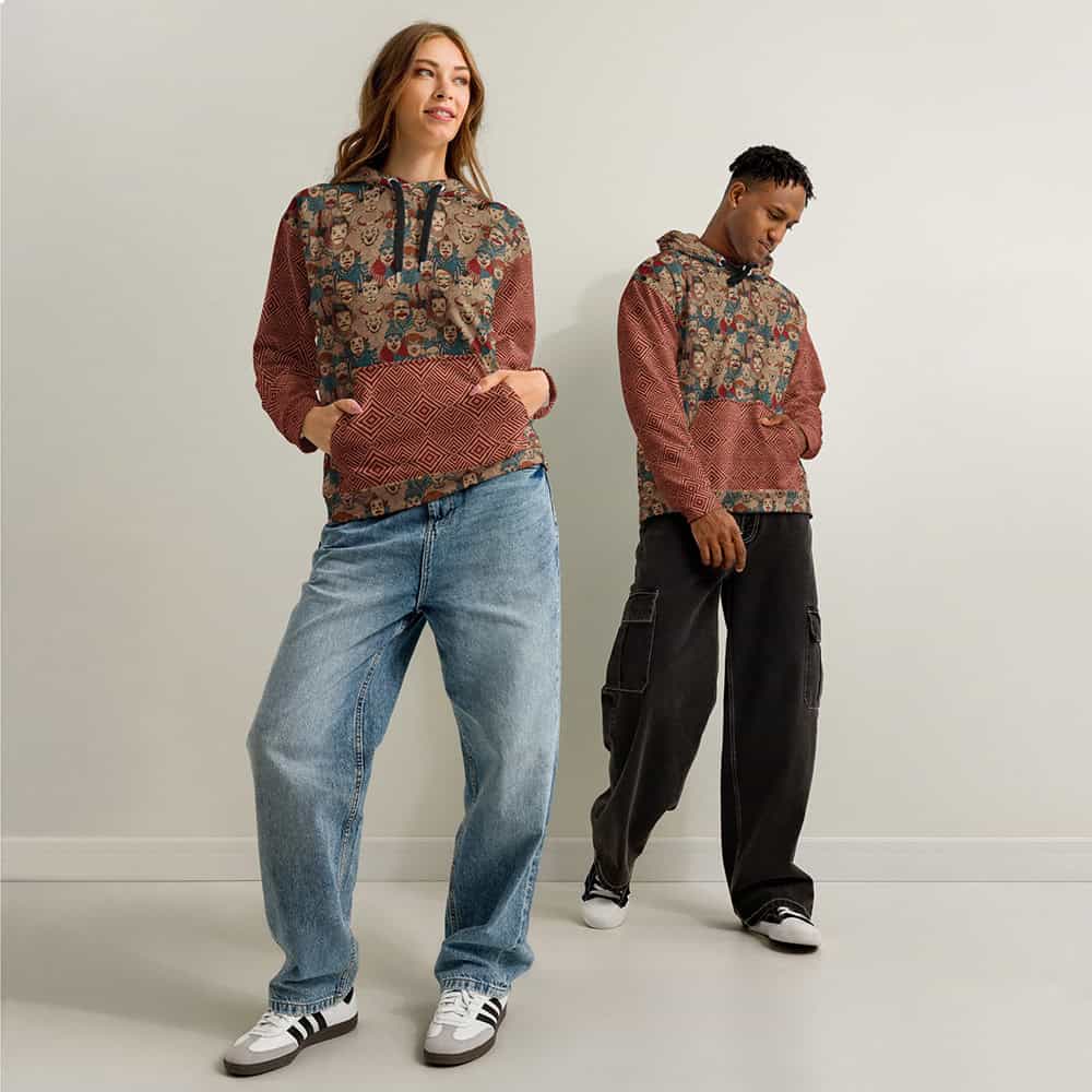 Man and woman wearing Creepy Circus Unisex Hoodie with allover vintage clown print in rust, tan, and teal.