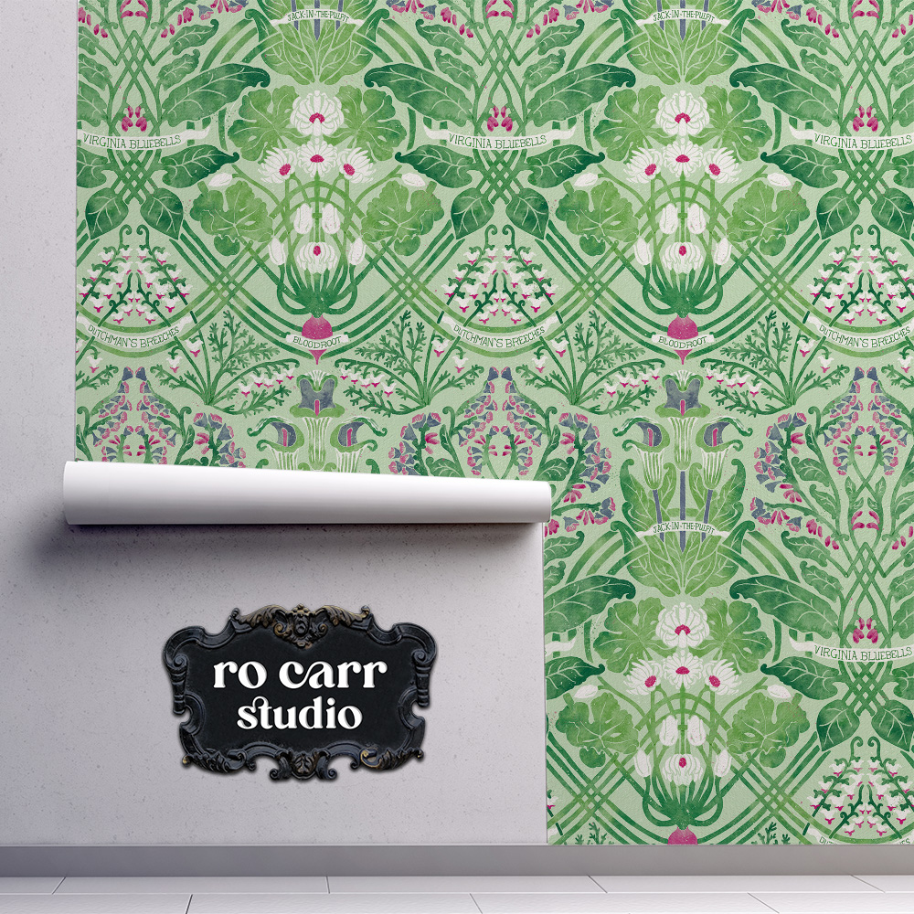 Rolled wallpaper in the same green Art Nouveau botanical print, unrolling against a wall.