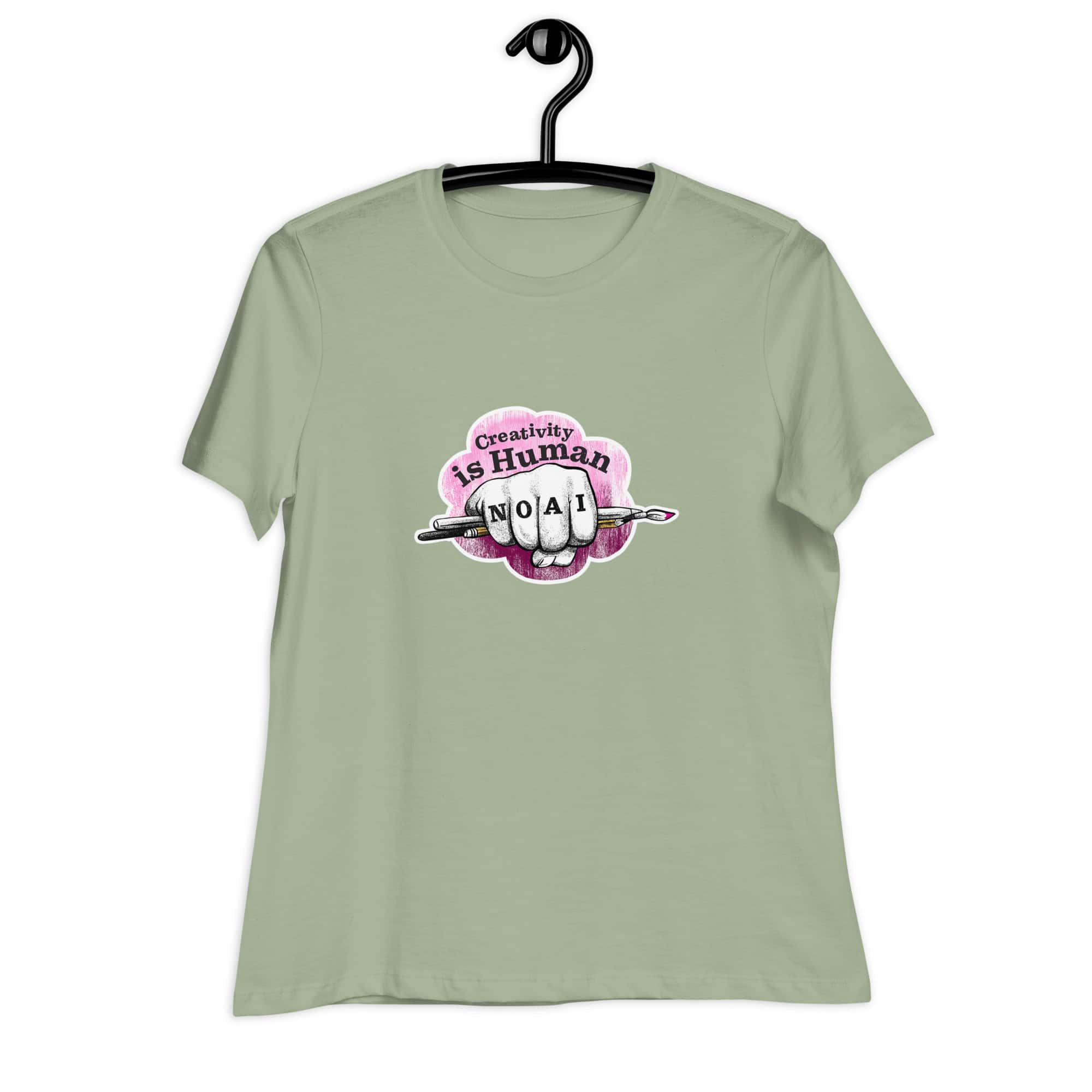 Creativity is Human No AI women's relaxed t-shirt in sage green with hand-drawn fist and paintbrush graphic.