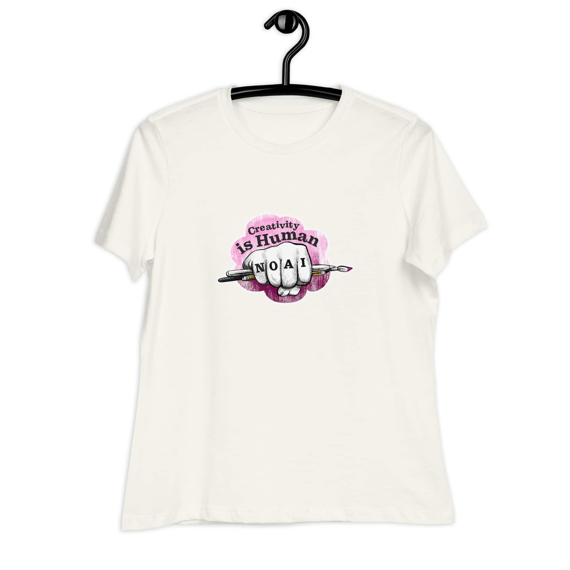 Creativity is Human No AI women's relaxed t-shirt in vintage white with hand-drawn fist and paintbrush graphic.