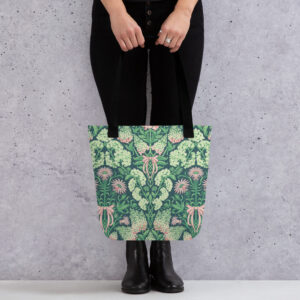 Pretty in Pinky tote carried by its handles against a concrete wall, full hydrangea print visible.