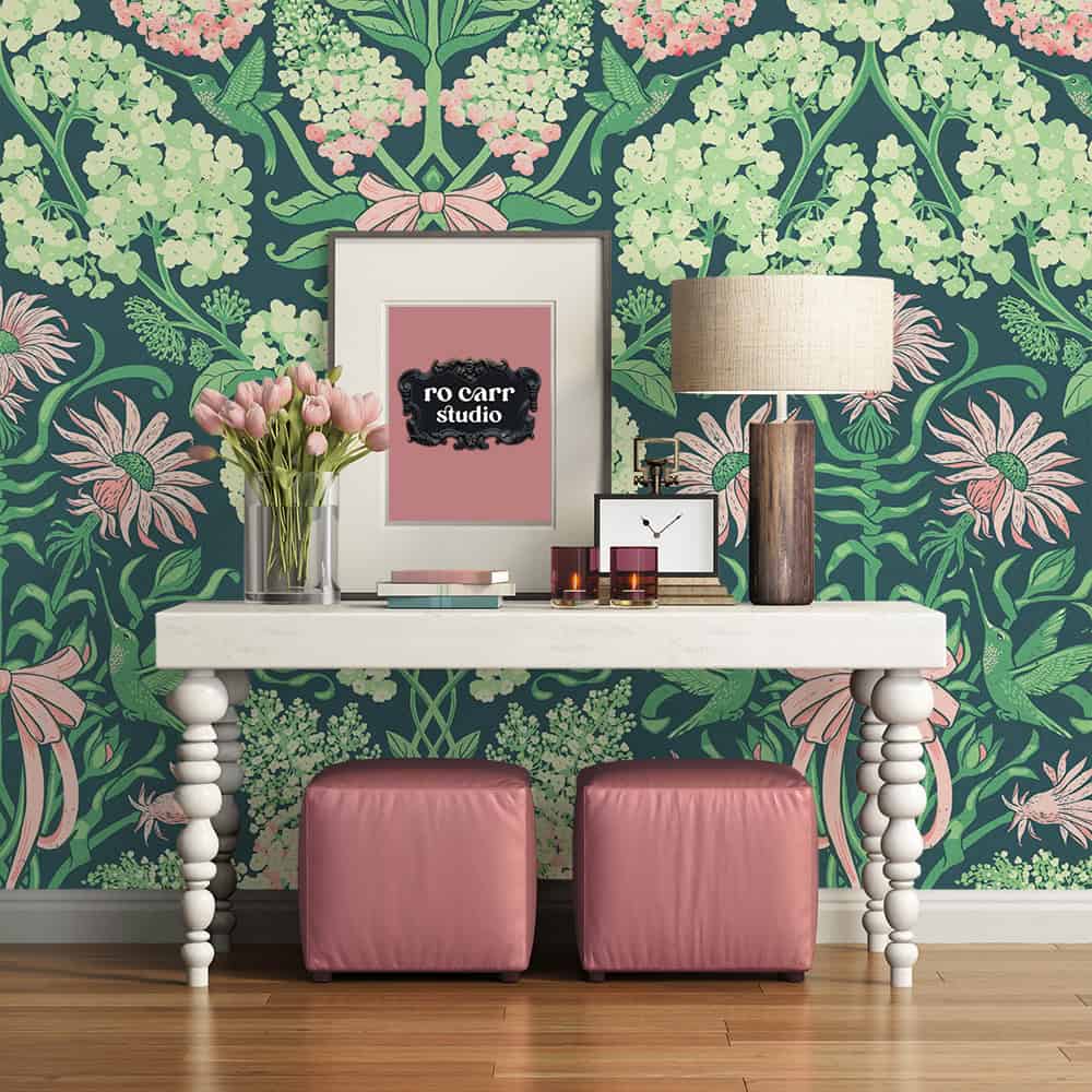 Console table with pink ottomans and pink tulips, hydrangea damask wallpaper in the background.