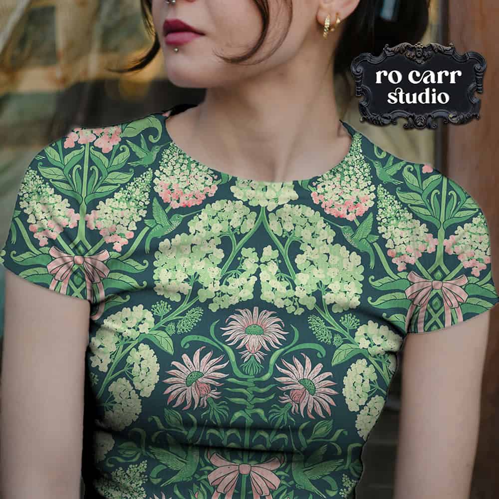Close-up of a hydrangea and ribbon print top on a woman, showing the design detail at the shoulder and neckline.