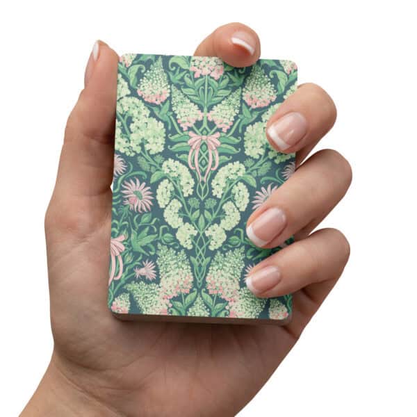 Hand holding the deck of cards, showing the print up close.