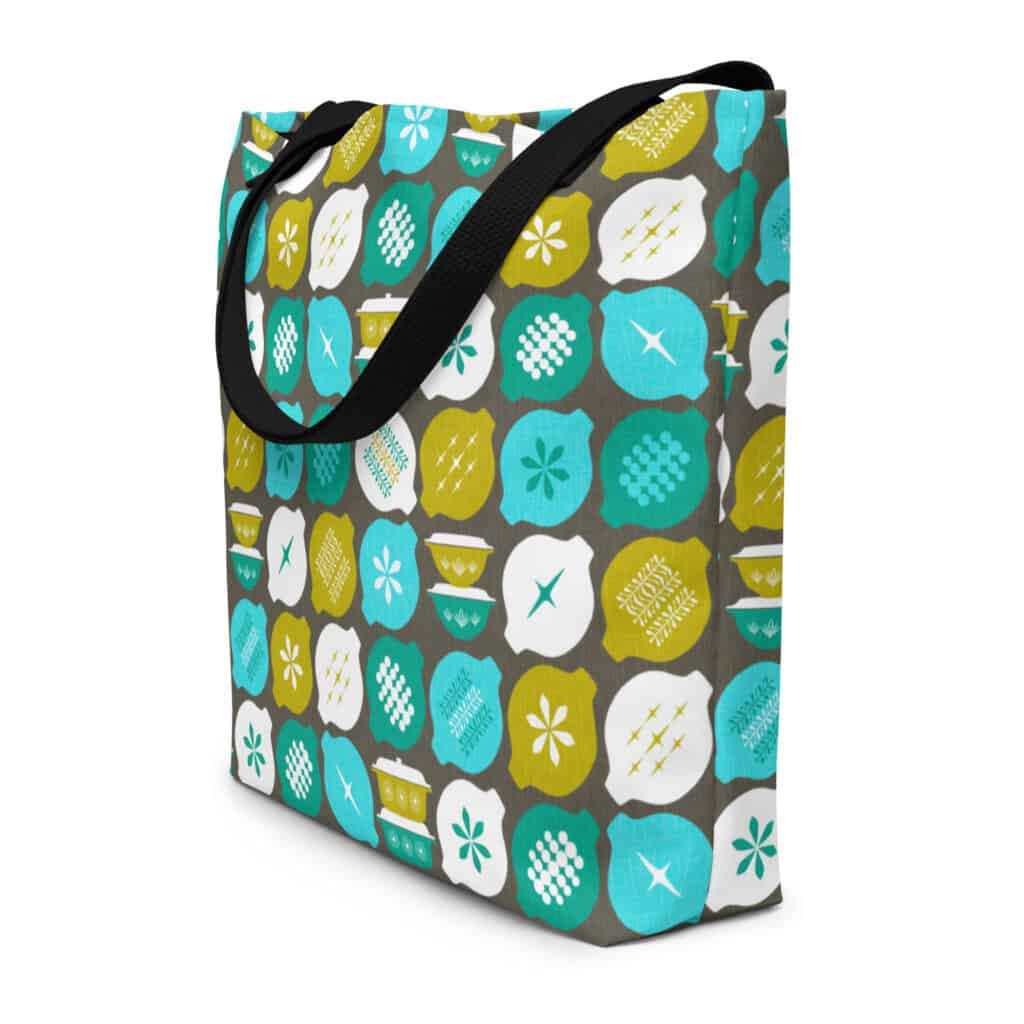 Hostess with the Mostest tote bag, in retro aqua and avocado on gray background, shown standing in three quarter view.