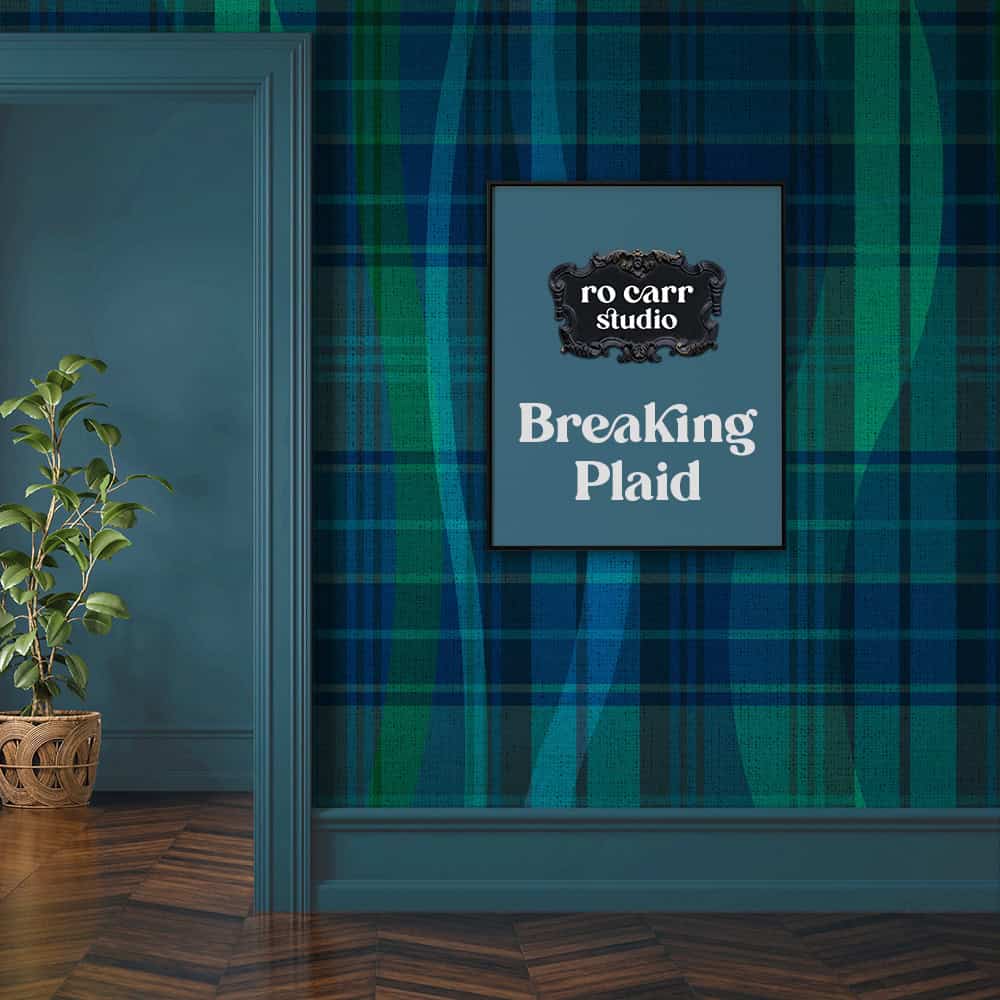 Framed "Breaking Plaid" print displayed on matching tartan wallpaper in a blue entryway.
