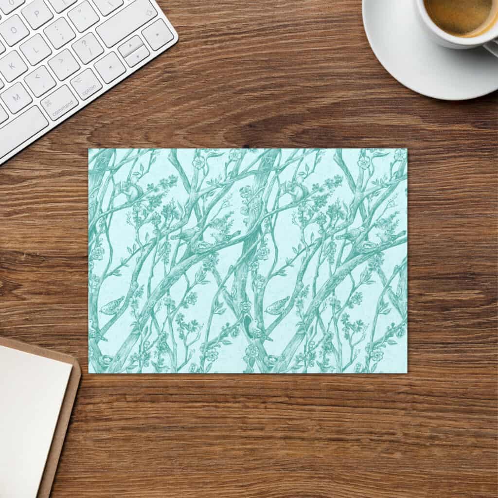 Layflat showing front side of card, printed with pattern in aqua.