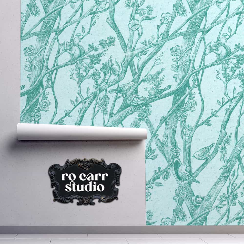 Wallpaper sample shown on wall displaying the Toile de Vie pattern in aqua.