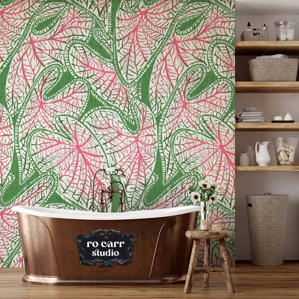 Copper soaking tub against block print leaf wallpaper, with open wooden shelves to one side.
