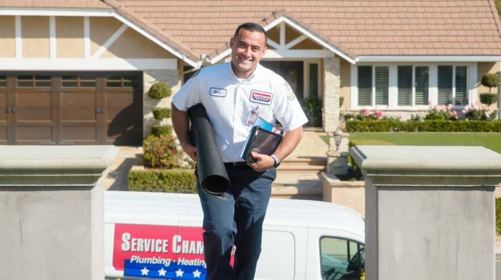A friendly Service Champions technician arrives with tools in hand, ready to provide trusted home comfort expertise and helpful service.
