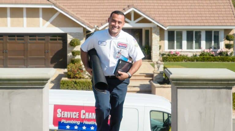 A friendly Service Champions technician arrives with tools in hand, ready to provide trusted home comfort expertise and helpful service.