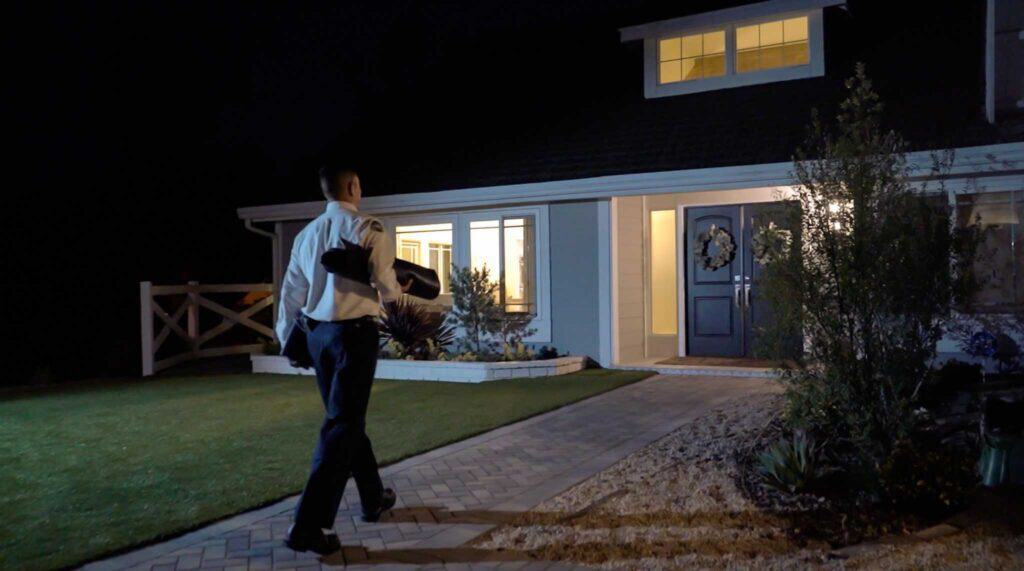 A Service Champions technician arrives at a welcoming, well-lit home at night, ready to provide trusted home comfort solutions.